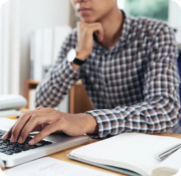 Person working on a laptop to choose an SAP training path  